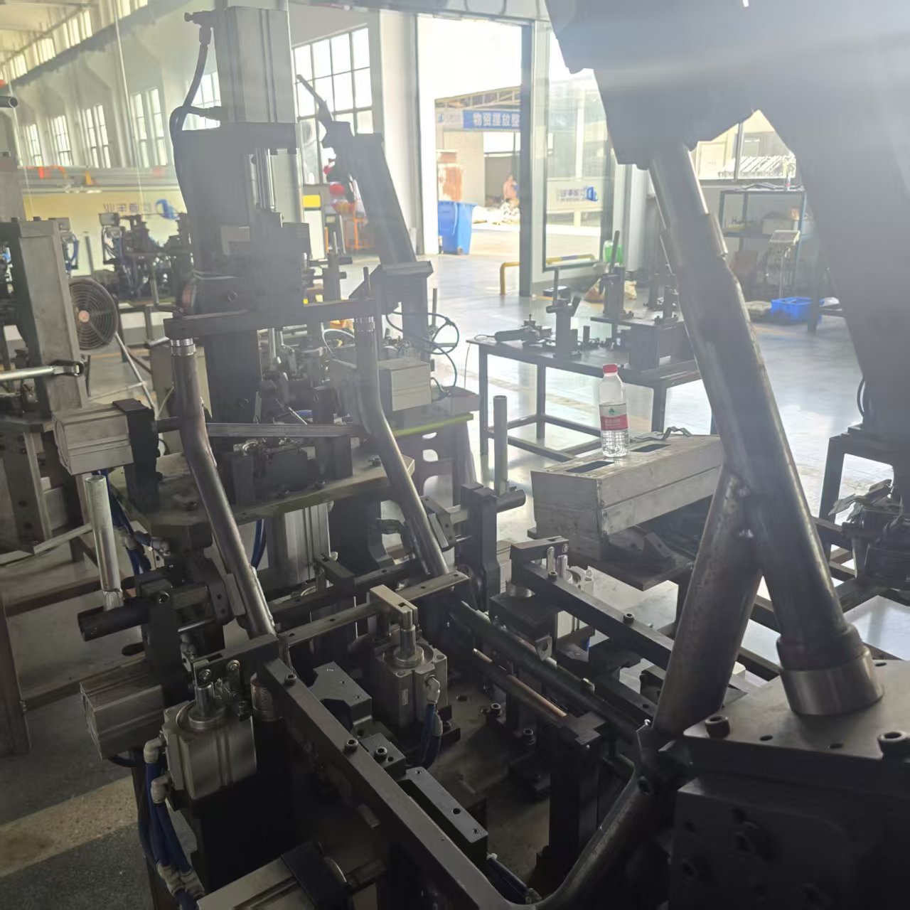 Frame tubes positioned in welding fixtures
